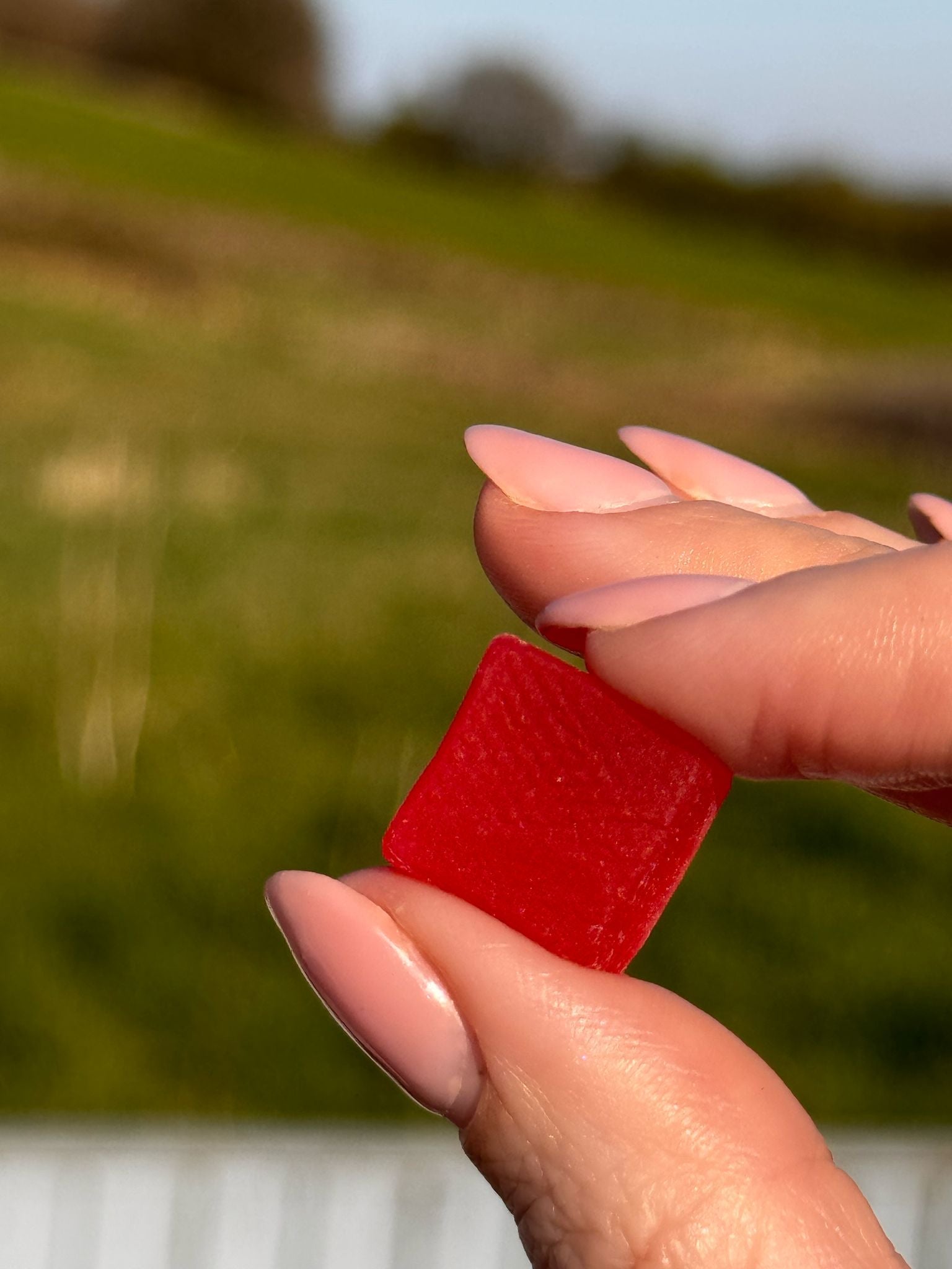 woman holding a bestrong creatine gummies in her fingers