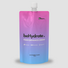 Gradient blue to pink 'behydrated' performance drink pouch on a light gray background