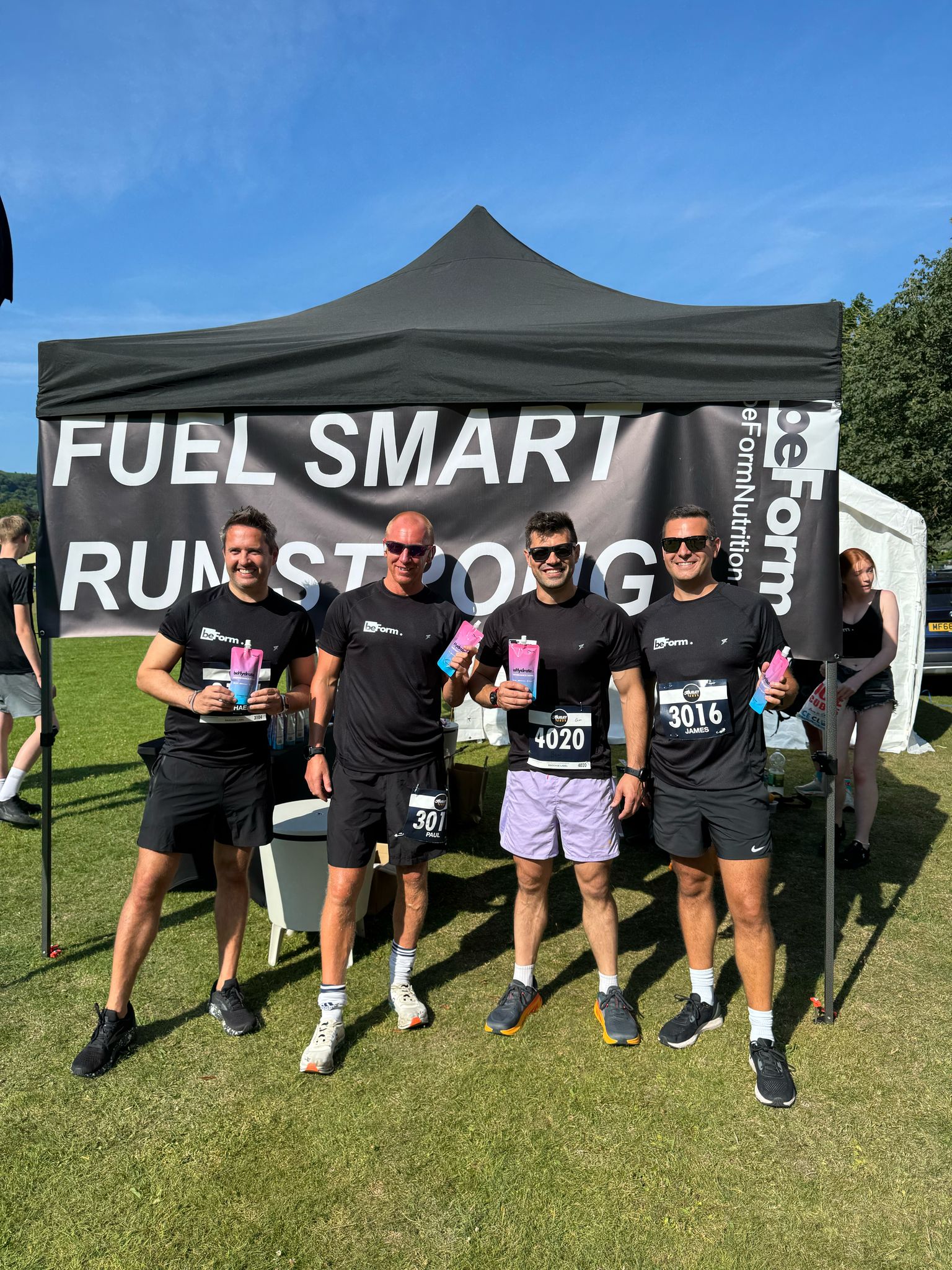 members of the beForm nutrition team stood under a black gazebo