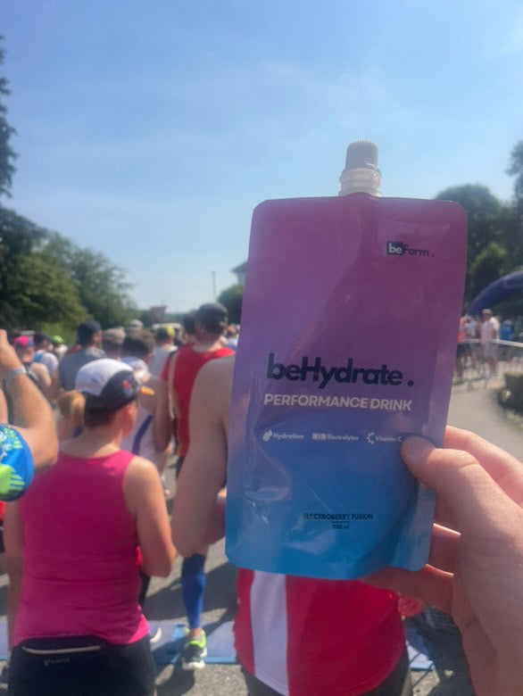 A pouch of beHydrate held up in a running race