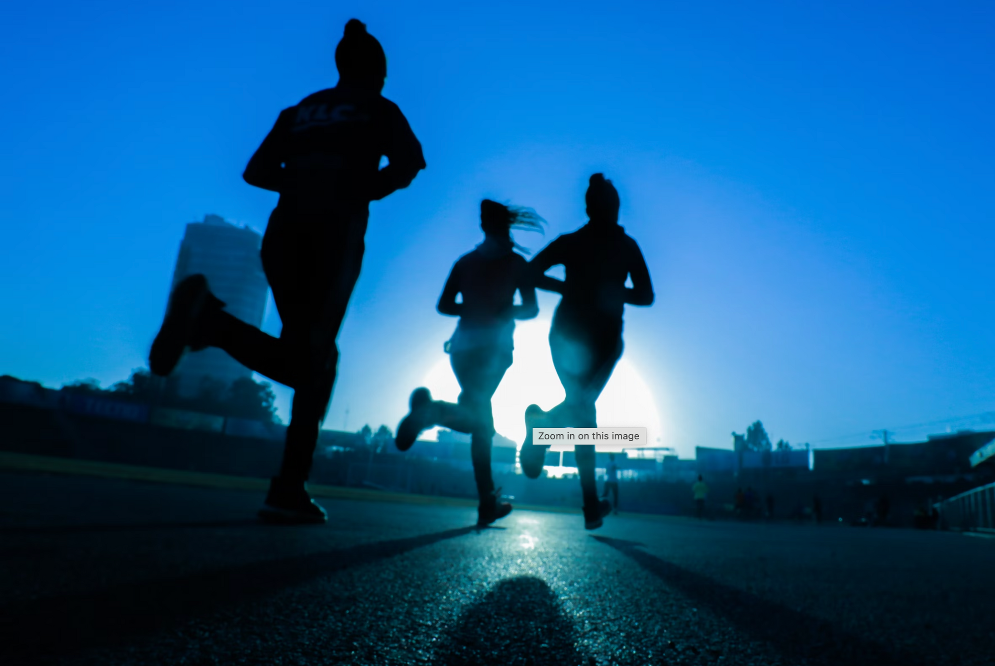 3 PEOPLE RUNNING INTO THE SUNLIGHT