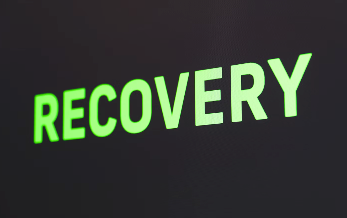 ILLUMINOUS RECOVERY GREEN LETTERS ON BLACK BACKGROUND