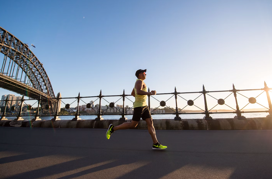 MAN RUNNING NEXT TO SYDNEY HARBOUR BRIDGE