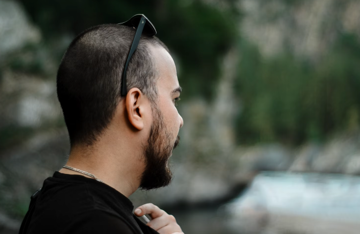 man with short dark hair and a beard