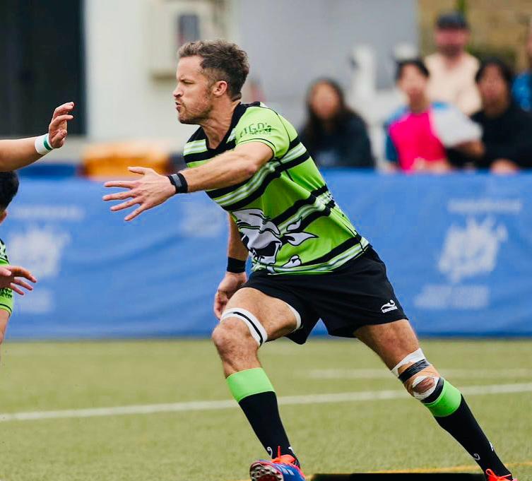 man running in a green shirt with black hoops