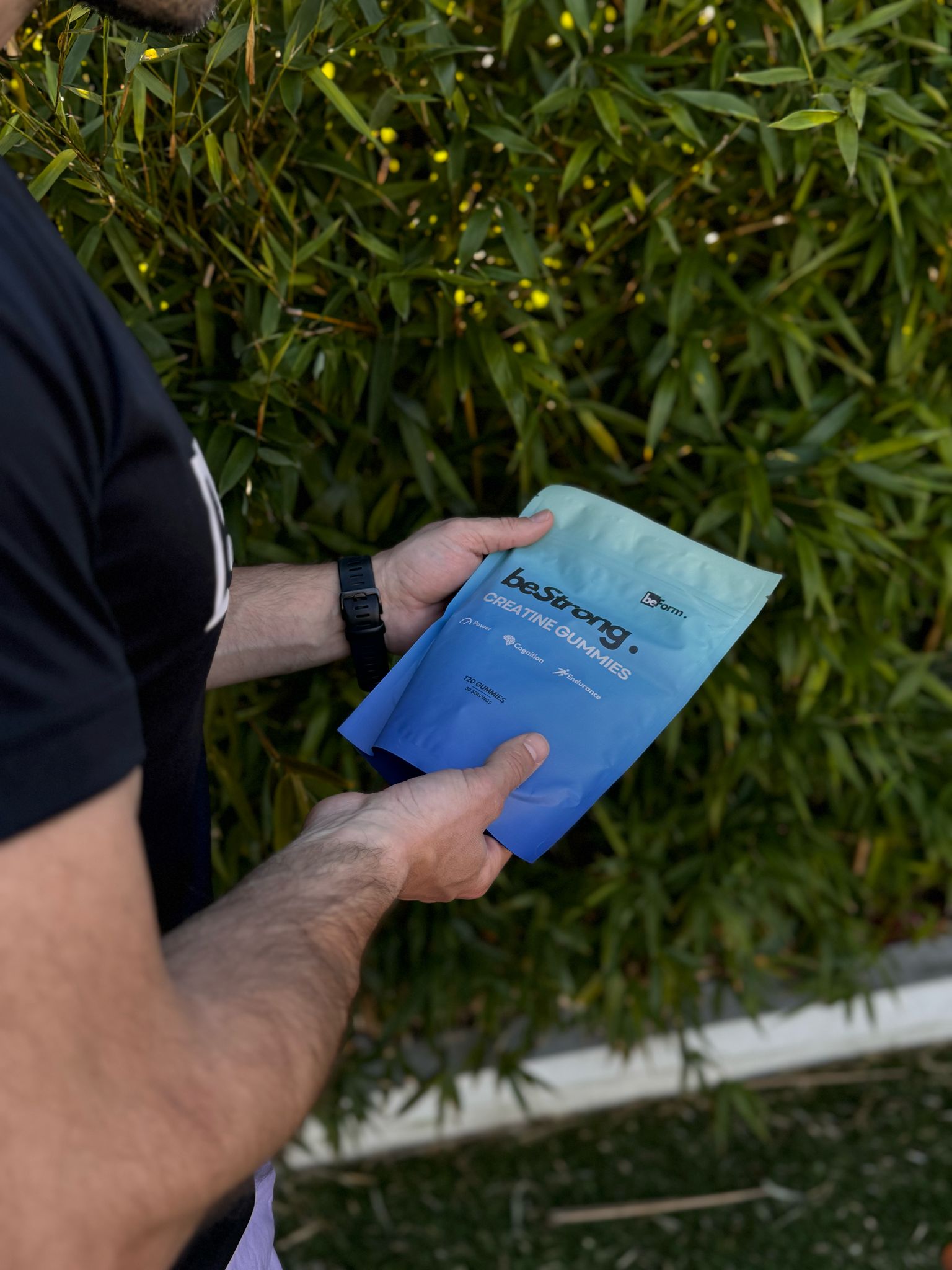 man holding a packet of bestrong creatine gummies