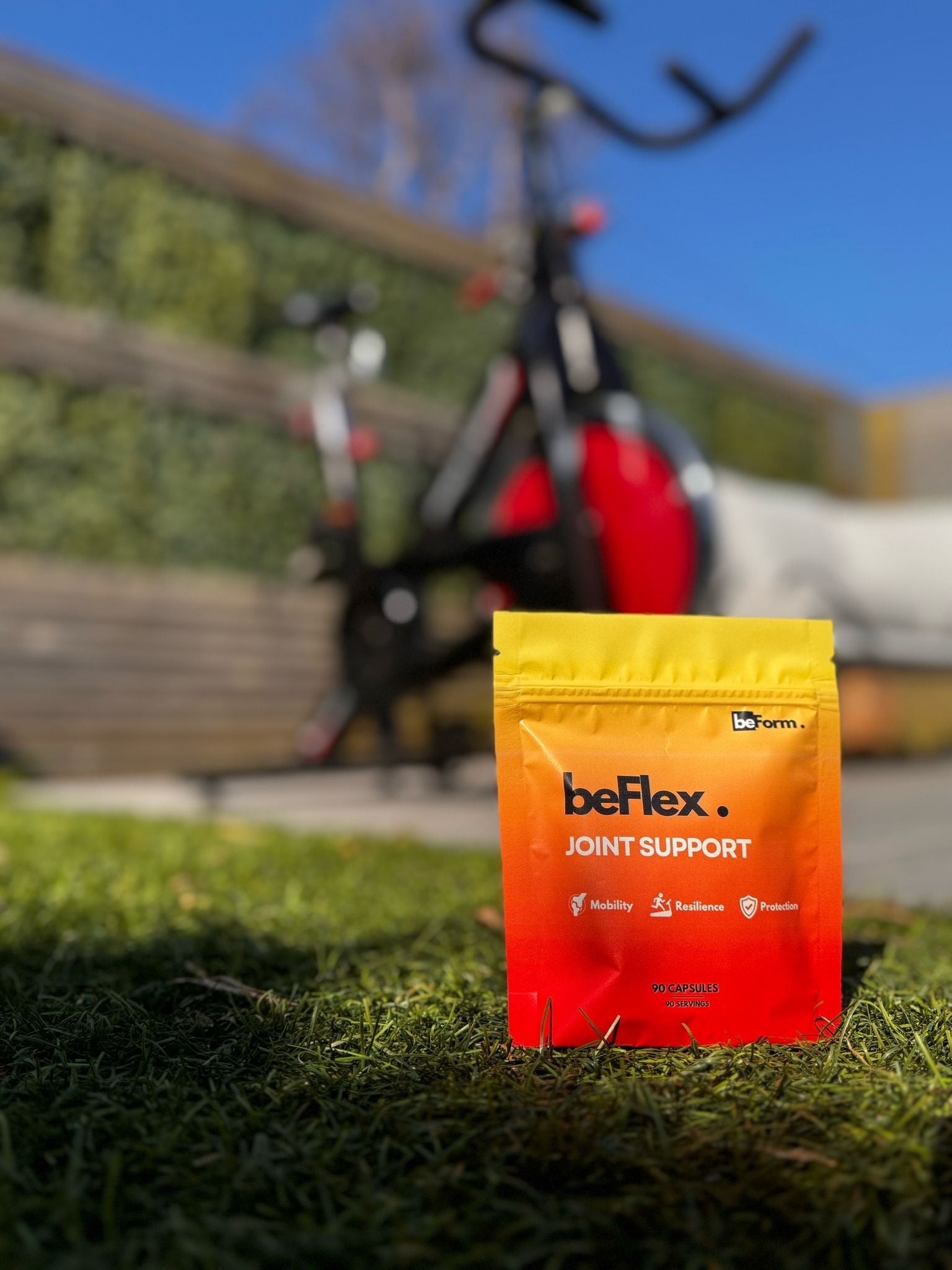packet of beflex on grass with a spin bike in the background