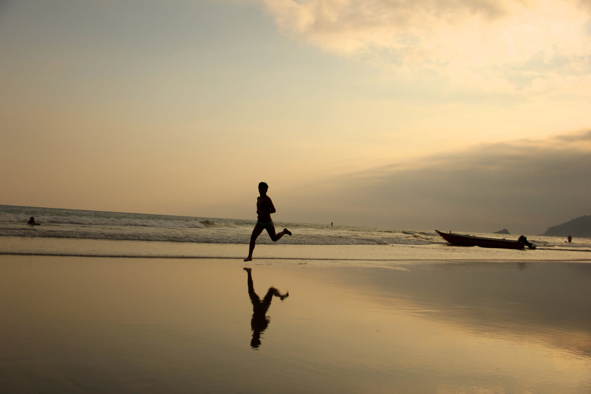 person runnng along beach in twilight