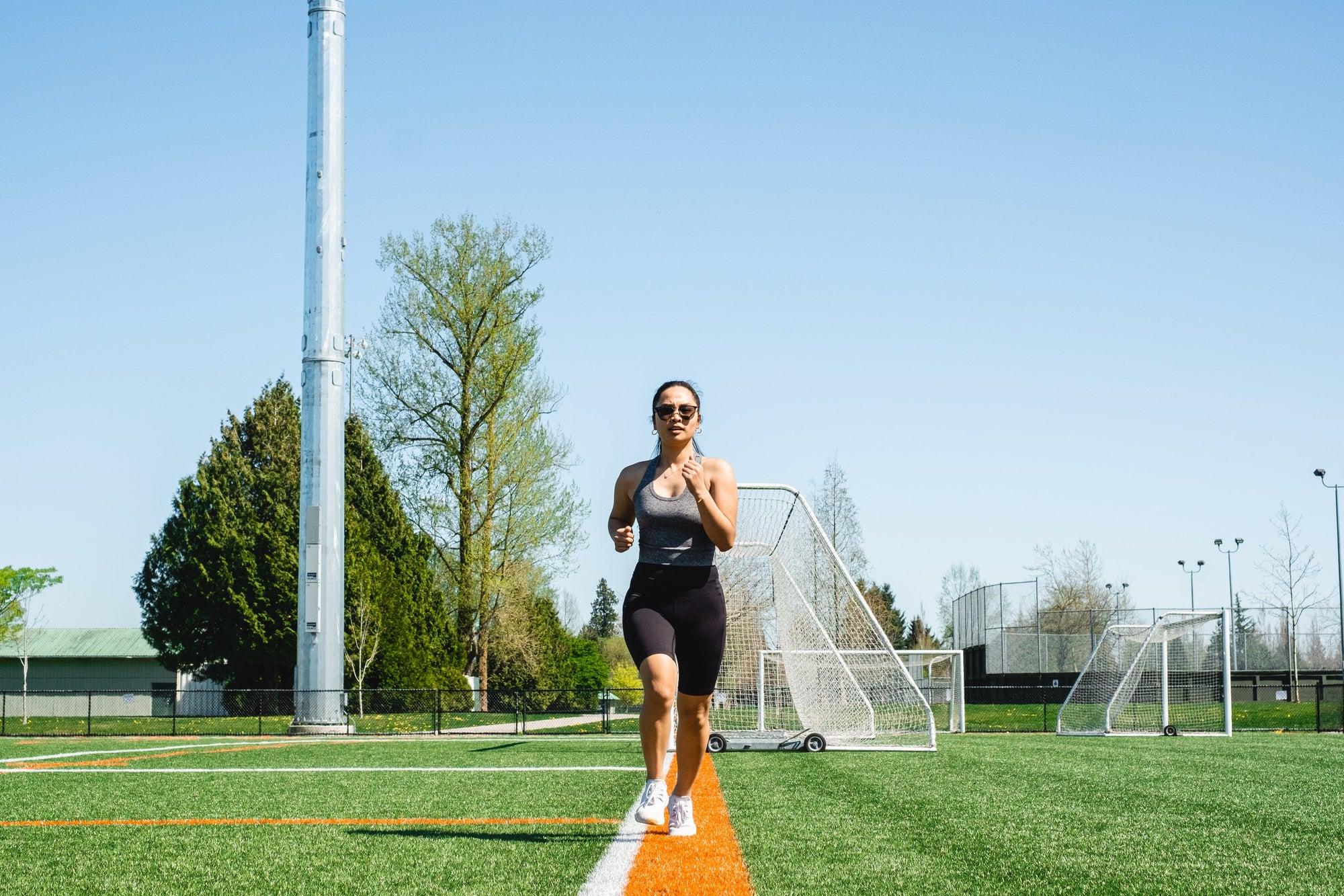 woman running down a white line