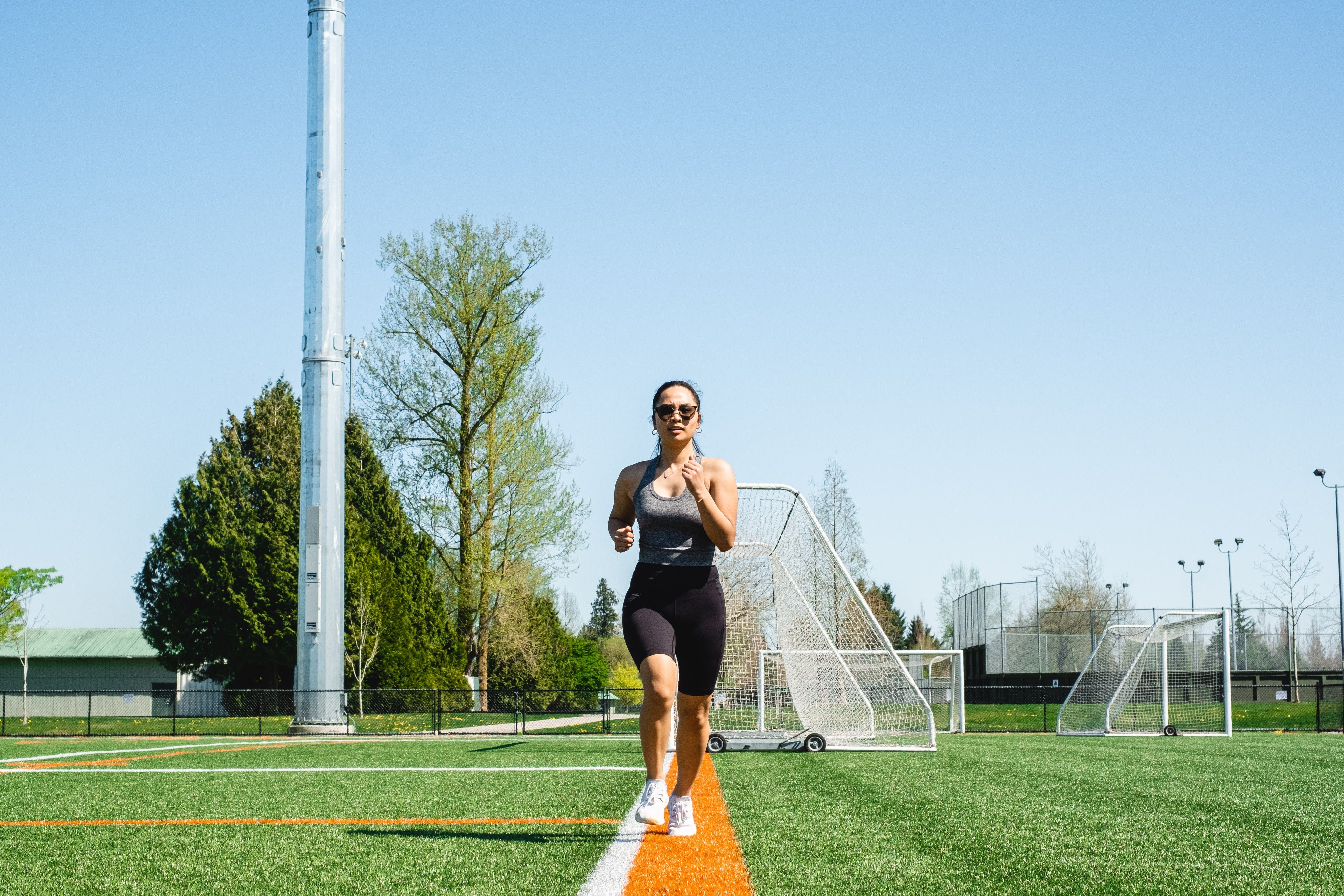 woman running down a white line