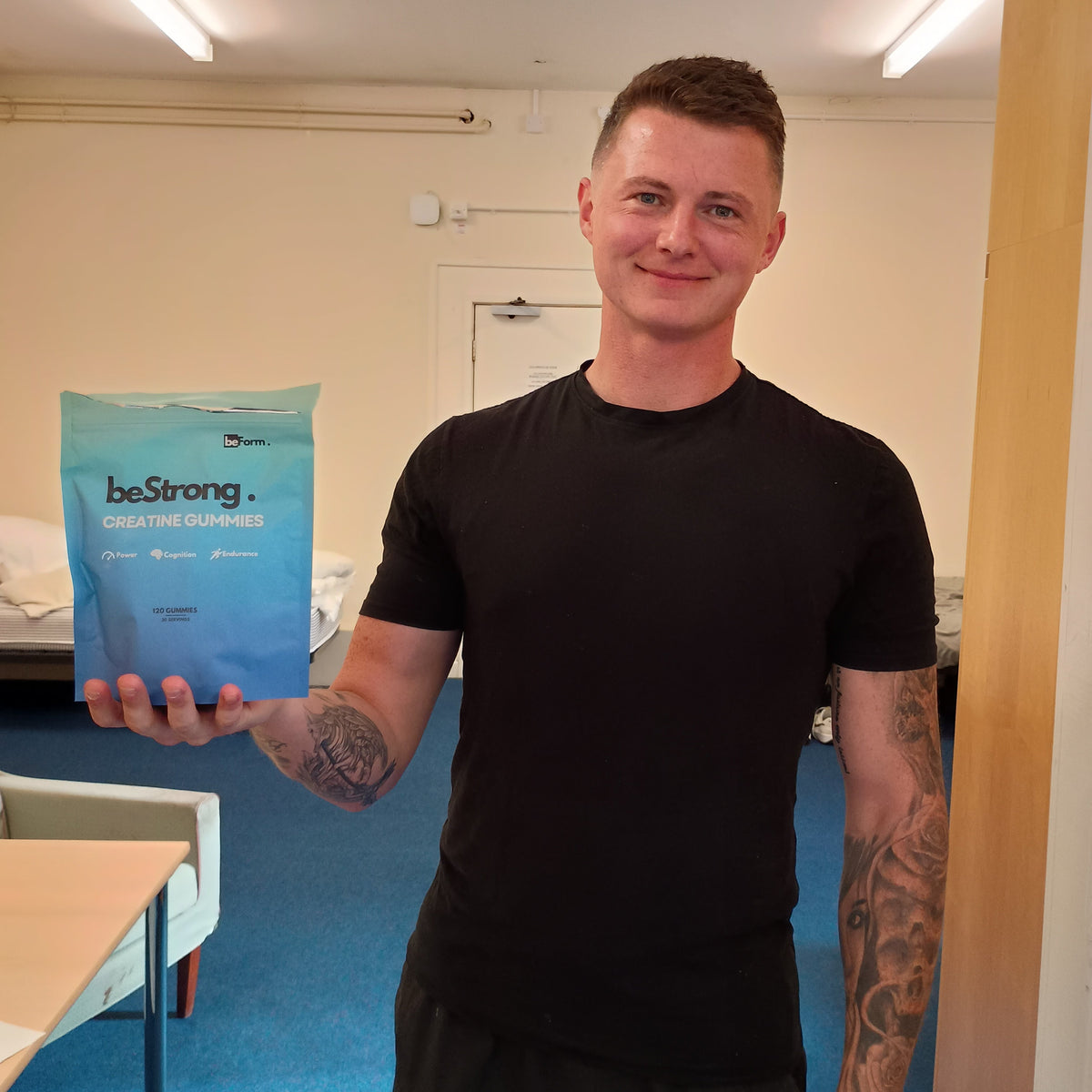 Person holding a packet of beStrong creatine gummies in an indoor setting