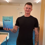 Person holding a packet of beStrong creatine gummies in an indoor setting