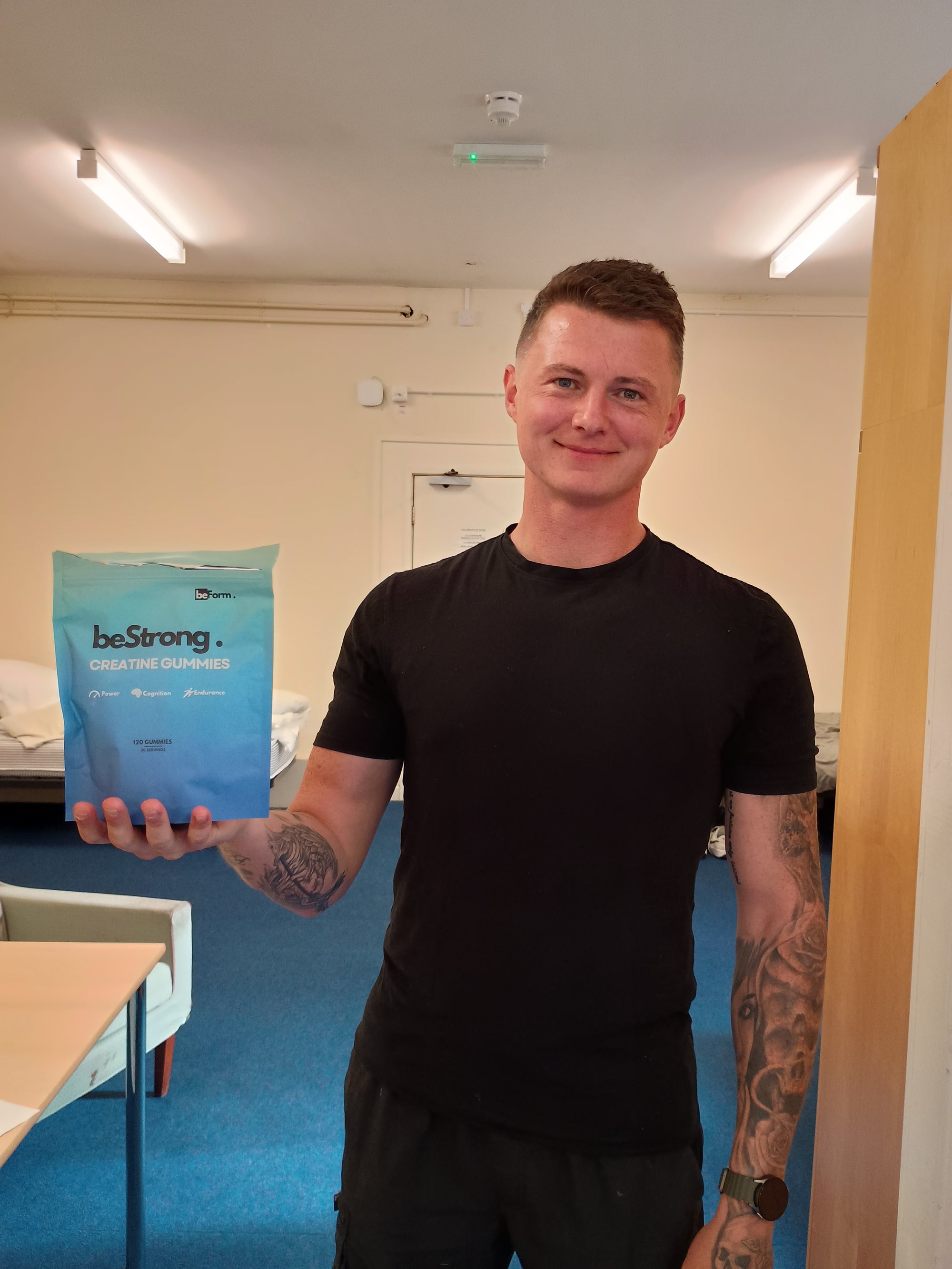 Person holding a packet of beStrong creatine gummies in an indoor setting
