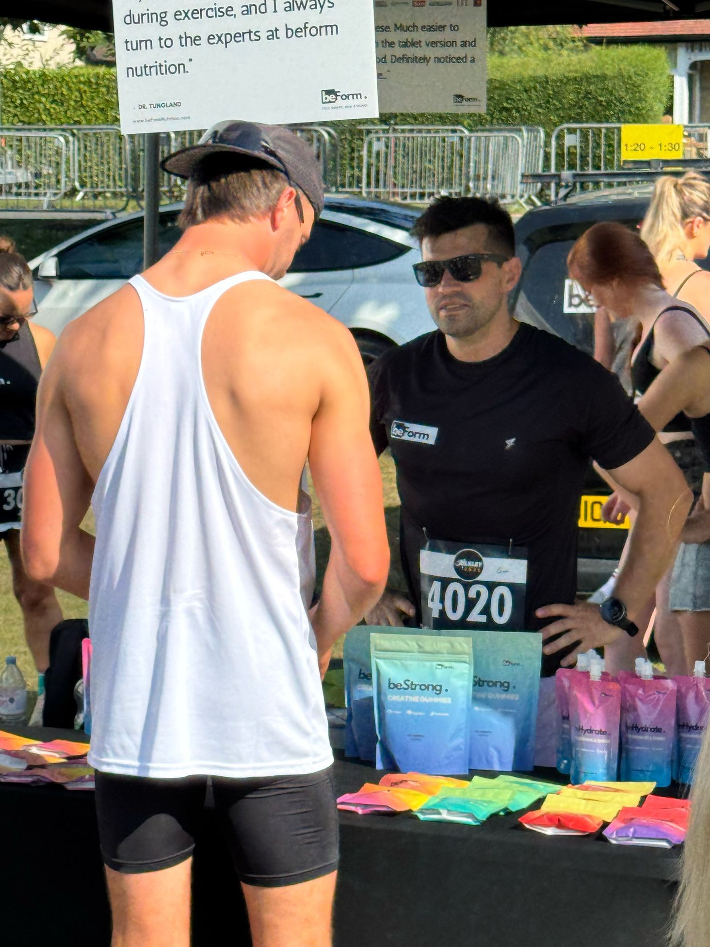 Person at a race event interacting with an official or volunteer.
