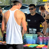 Person at a race event interacting with an official or volunteer.