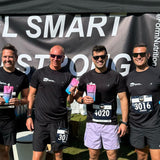 Four men in running gear standing in front of a beForm Nutrition 'Fuel Smart Run Strong' tent with a banner.