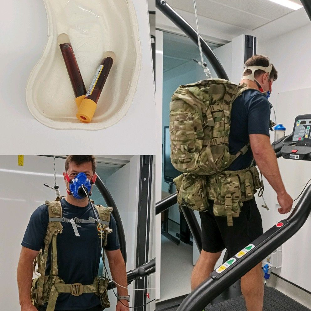 Person wearing a gas mask and backpack in a laboratory setting