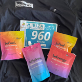 Collection of sports nutrition products including 'befuel' packets and a race bib on a black background.