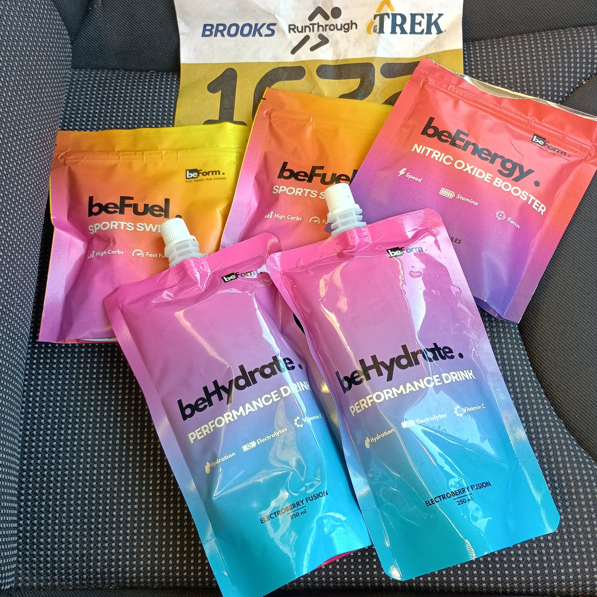 Colorful behydrate sports drink and befuel packs on a car seat