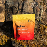 A pouch of beFlex Joint Support supplement placed on a rock surface with moss.