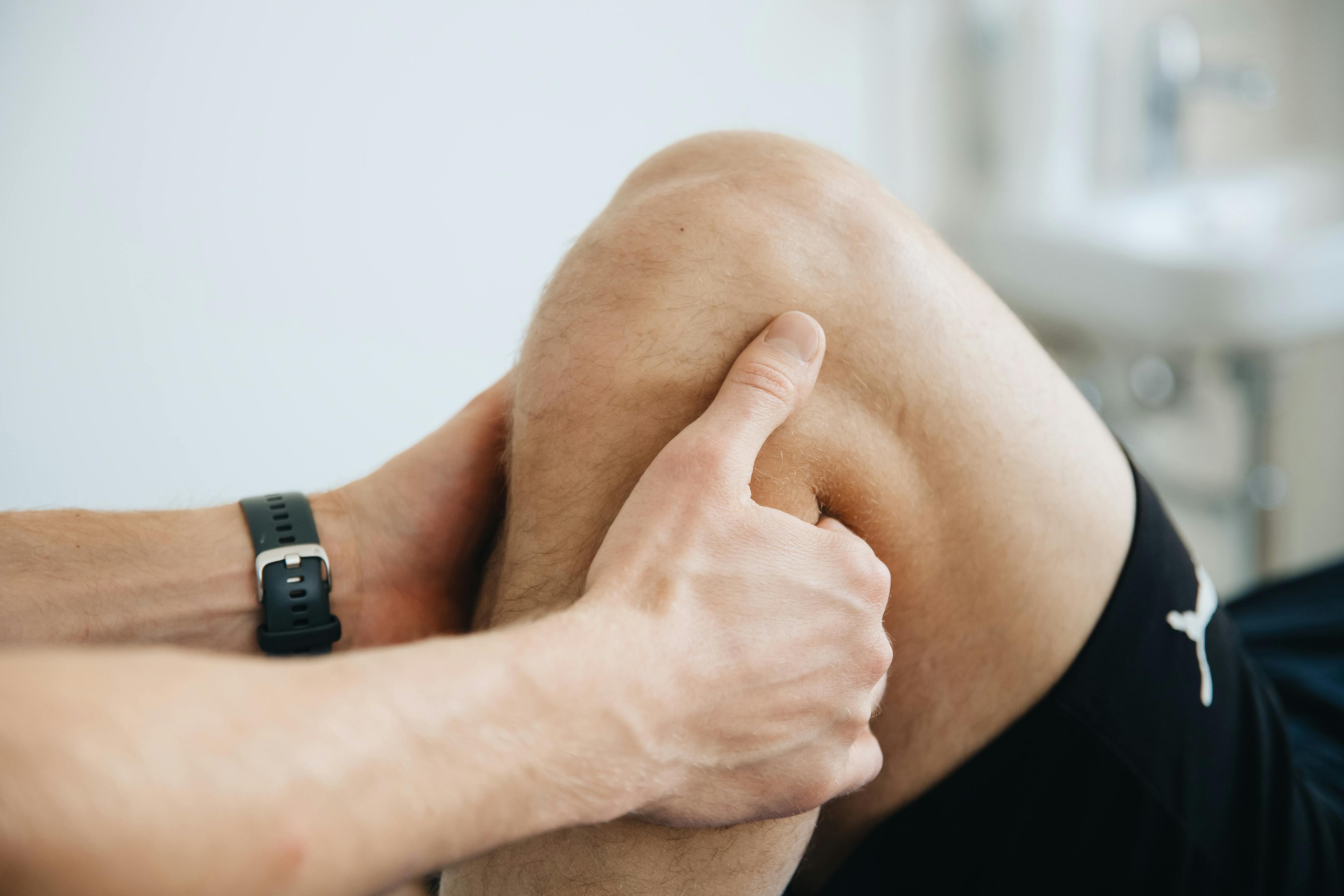 person holding calf muscle in a stretching routine.