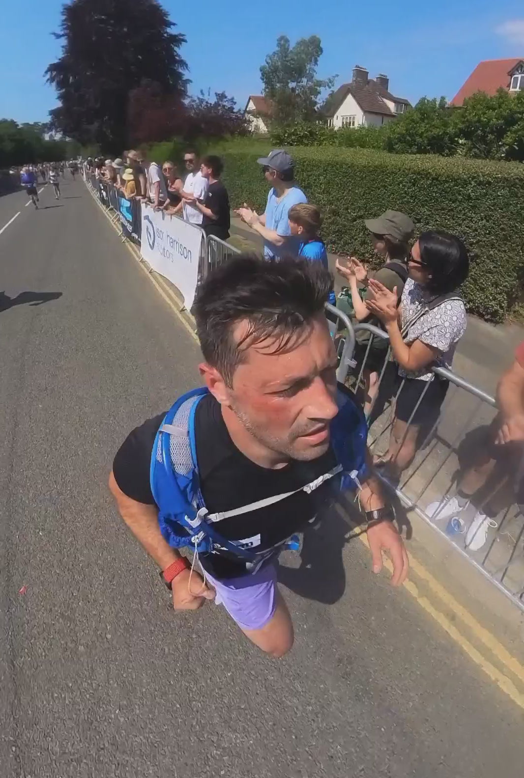 person running in the ilkley half marathon with people watching